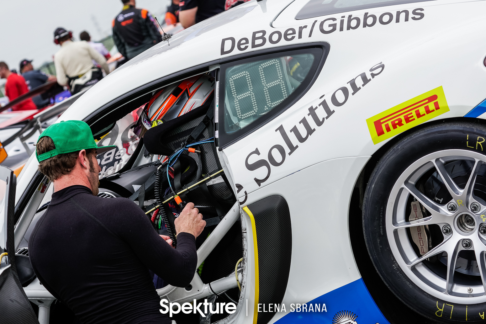 Earchphoto - Derek assisting Sean on pre-grid at COTA. 