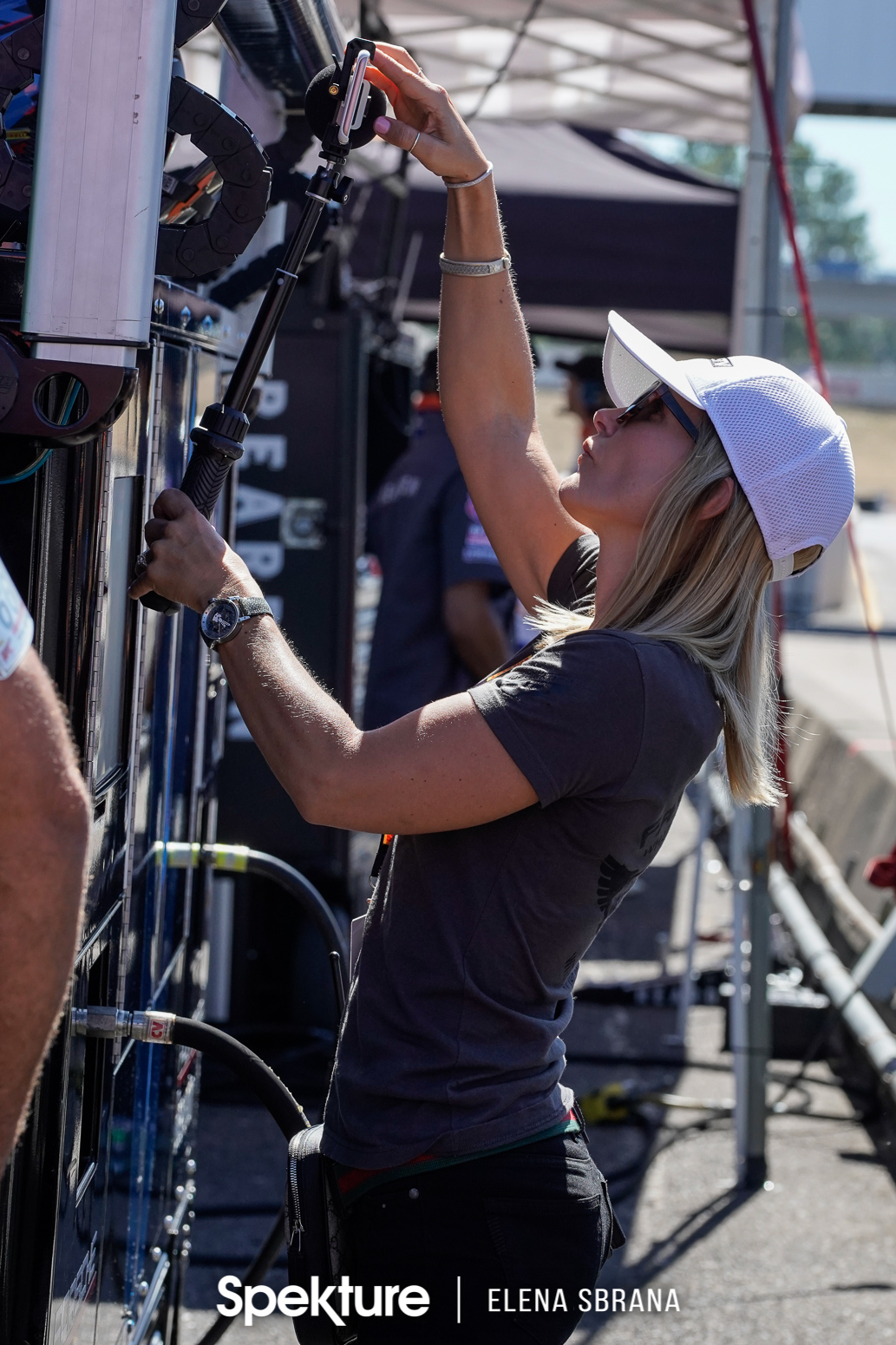 Earchphoto - Brooke filming in pit lane, capturing the emotions as the team members follow the race. 